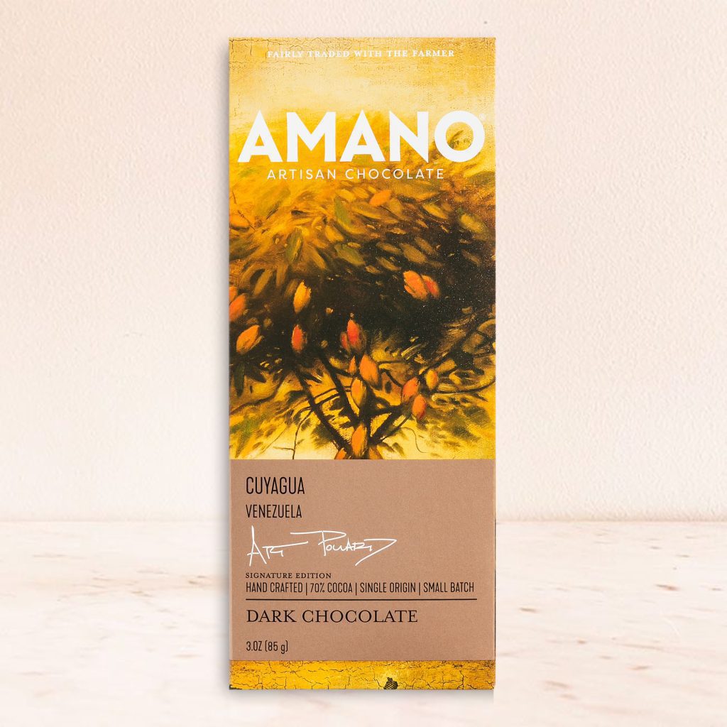Chocolate bar packaging features a vibrant design with yellow and orange foliage, labeled "Amano Artisan Chocolate, Cuyagua, Venezuela, Dark Chocolate."