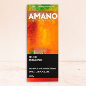 Bar of Amano Artisan Chocolate with vibrant orange and green packaging on a light surface. Labels read "Dos Rios," "Dominican Republic," and "Dark Chocolate."