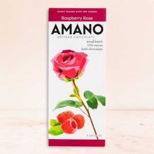 Artisan chocolate packaging, featuring a vibrant red rose and raspberries on a white background. Text reads "Amano Raspberry Rose, 55% cocoa." Elegant and refined design.