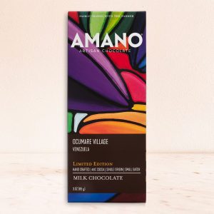 Amano chocolate bar with vibrant geometric artwork, featuring bold colors like purple, red, and orange. Text includes "Ocumare Village" and "Milk Chocolate."