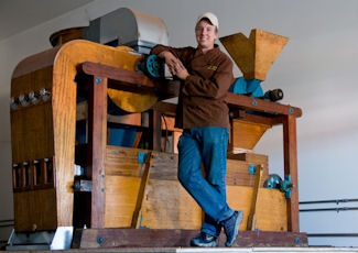 Amano’s Winnowing Machine along with Amano’s founder, Art Pollard. It was built in the 1920’s or 1930’s and refurbished at Amano’s factory.