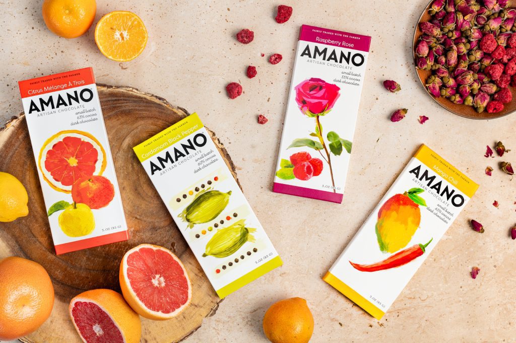 A display of amano's new fruit-flavored protein bars in various vibrant packaging designs