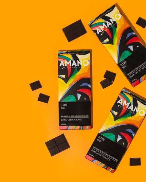 An Amano chocolate bar displayed on a wooden surface highlighting its smooth surface and branding